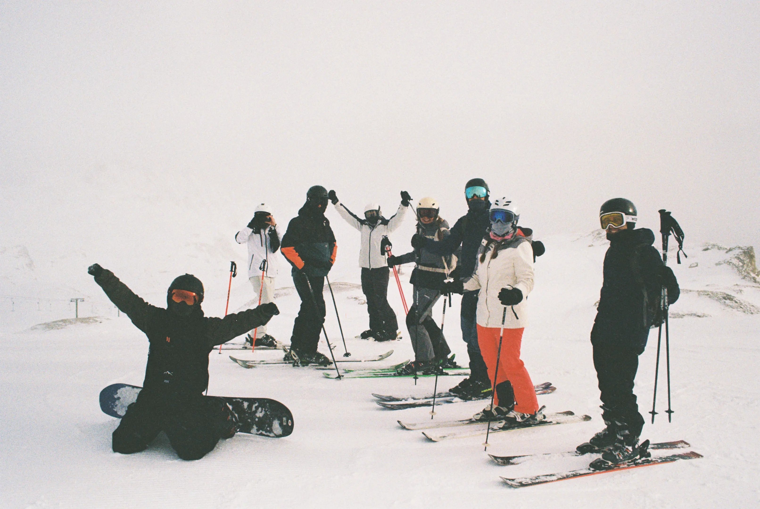 The crew posing together with alpine panorama in the background